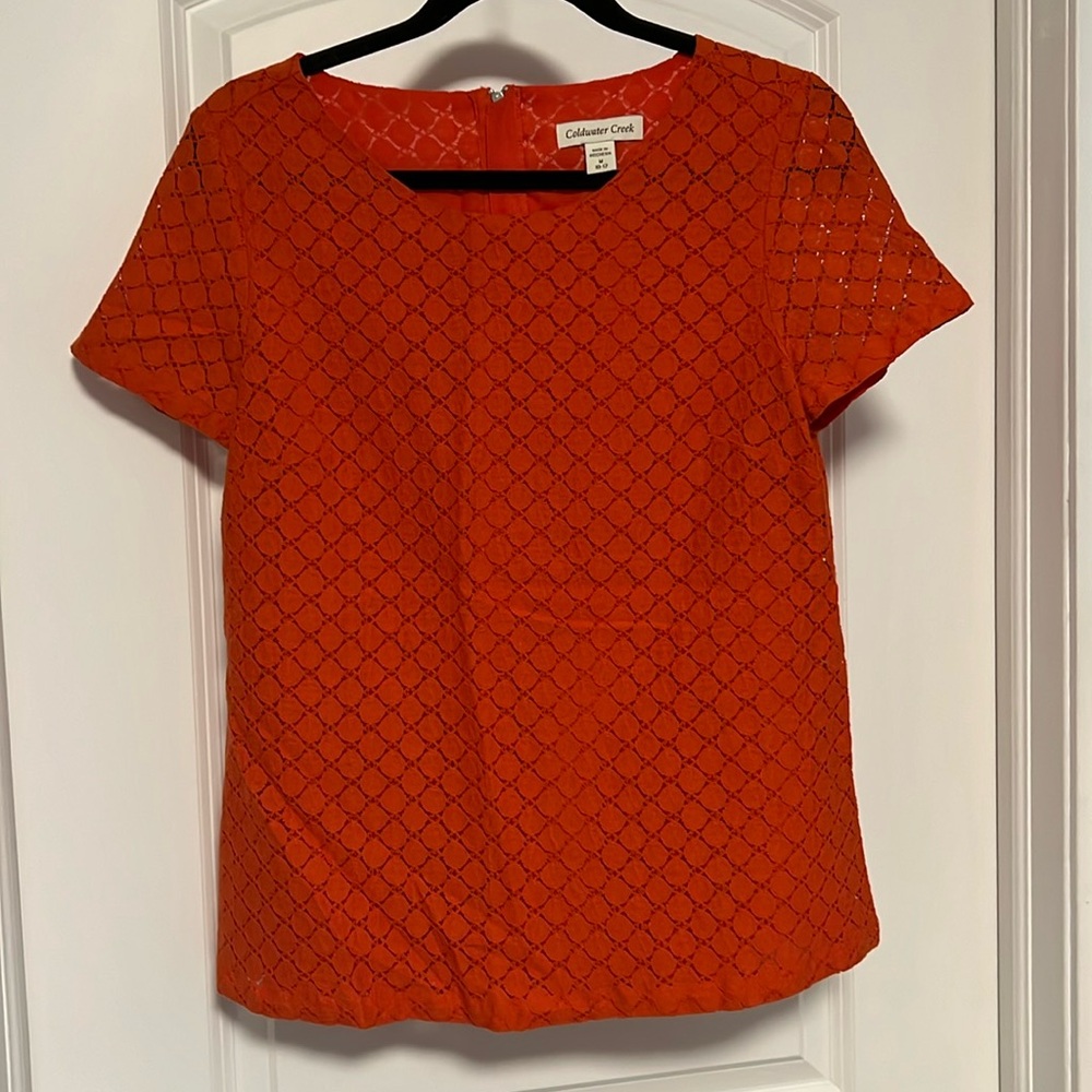 Orange short sleeve blouse. Back zipper. Size M (10-12)
